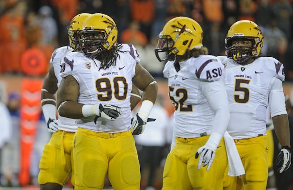 Redshirt junior defensive tackle Will Sutton (90), redshirt sophomore linebacker Carl Bradford (52) and junior defensive end Junior Onyeali (5) stand at the line in ASU’s 36-26 loss to Oregon State on Saturday night. (Photo courtesy of Neil Abrew/The Daily Barometer)