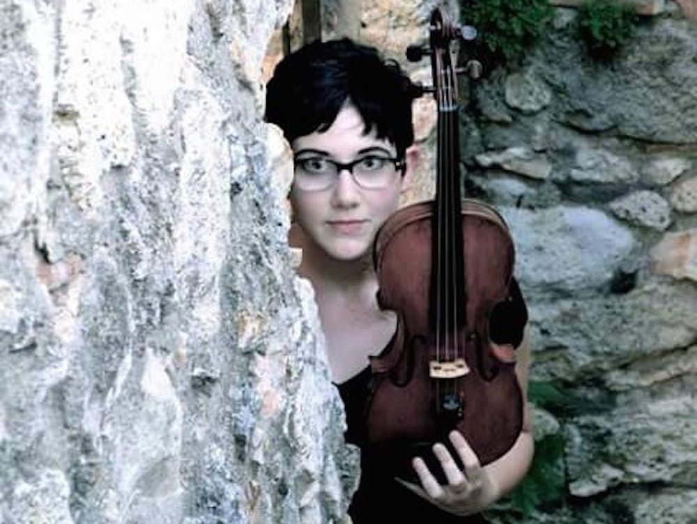 Alexandra Birch poses for a photo with her violin.