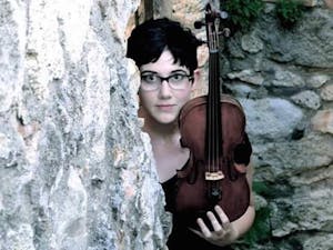Alexandra Birch poses for a photo with her violin.