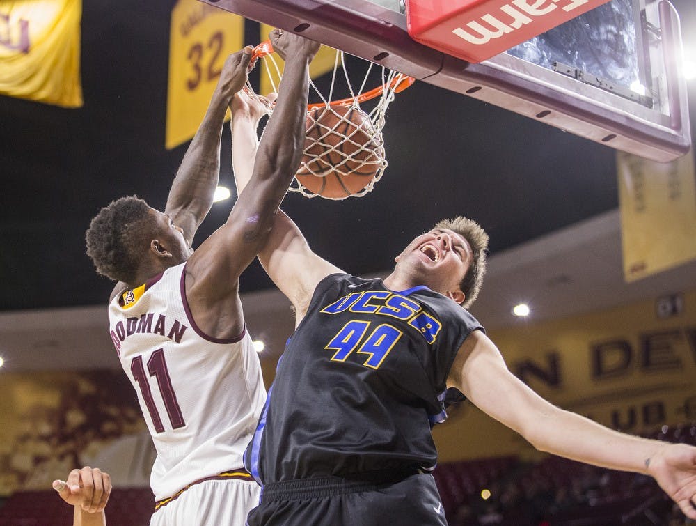 Arizona State Sun Devils forward Savon Goodman, left, dunks over UCSB forward Sam Beeler at Wells Fargo Arena in Tempe on Sunday, Nov. 29, 2015. The Sun Devils defeated the UC Santa Barbara Gauchos, 70-68.