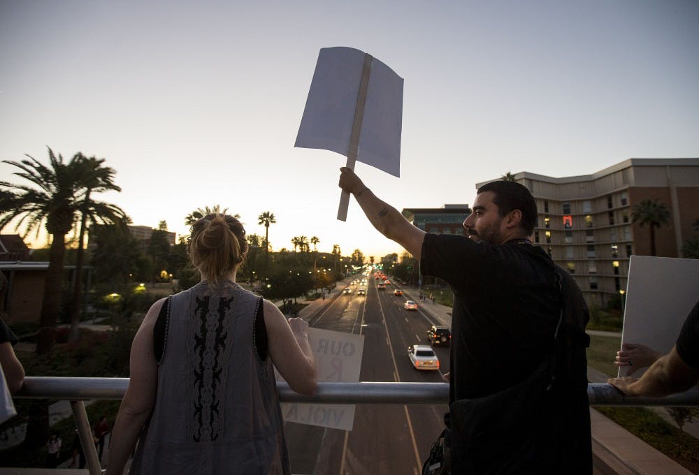 Protestors gather on the University Drive bridge during a protest of the 2016 presidential election results near the Old Main building on the ASU Tempe campus on Friday, Nov. 11, 2016. 