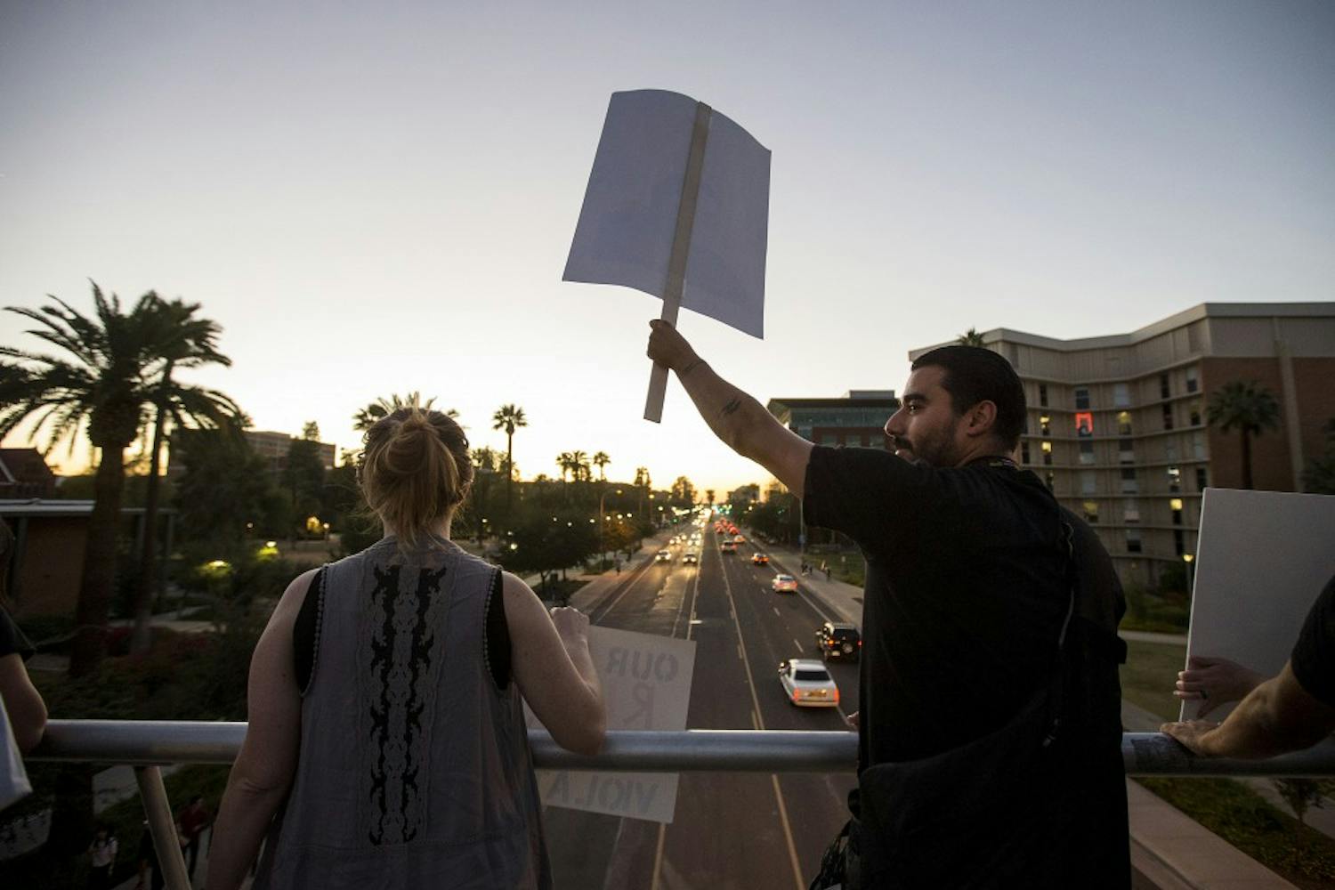 Protestors gather on the University Drive bridge during a protest of the 2016 presidential election results near the Old Main building on the ASU Tempe campus on Friday, Nov. 11, 2016. 