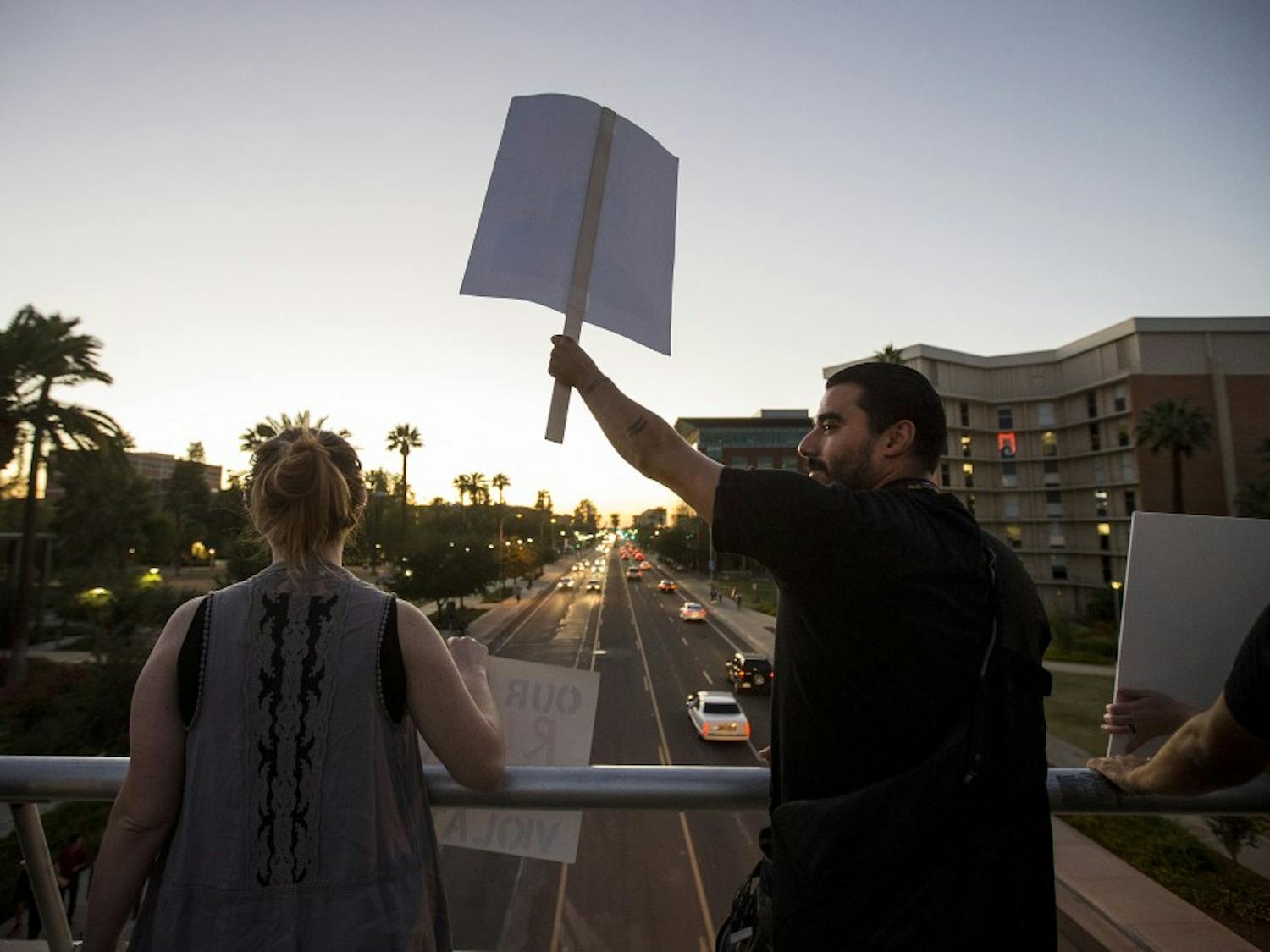 Protestors gather on the University Drive bridge during a protest of the 2016 presidential election results near the Old Main building on the ASU Tempe campus on Friday, Nov. 11, 2016. 