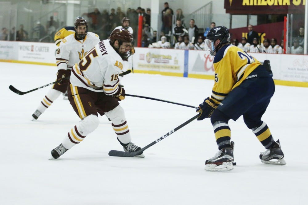 Jr. Wade Murphy (15) faces off against defense in the ASU versus Southern New Hampshire game at the Oceanside Ice Arena on Friday Jan. 20, 2017.