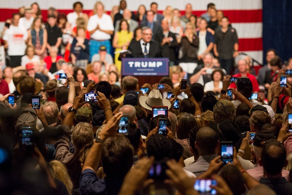 Attendees take photos and videos on their cell phones while Maricopa County Sheriff Joe Arpaio speaks about illegal immigration on Saturday, July 11, 2015, at the Phoenix Convention Center.