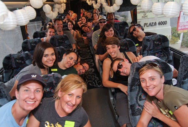 HAPPY TRAILS: Volunteers pose before leaving The Clothing Silo in Phoenix Tuesday afternoon.  The volunteers sorted clothing as part of The Do Good Bus with Foster the People, who played in Scottsdale Tuesday night. (Photo by Lisa Bartoli)