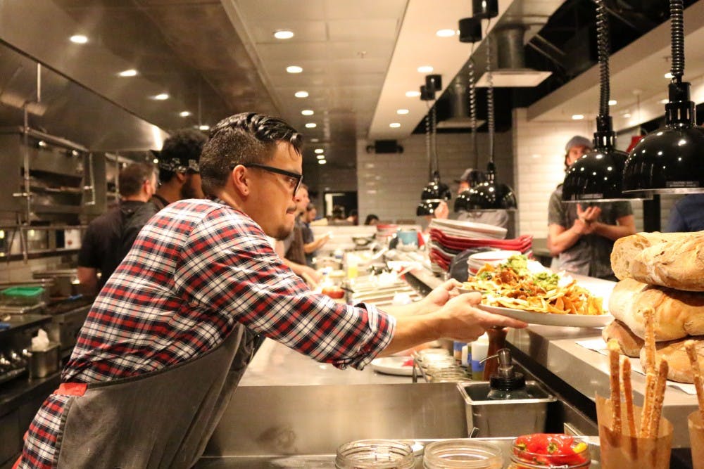 Ruben Perezthica, a lead line cook, compleltes a dish and puts it out to be served at Culinary Dropout in Tempe on Wednesday, Sept. 14, 2016. 