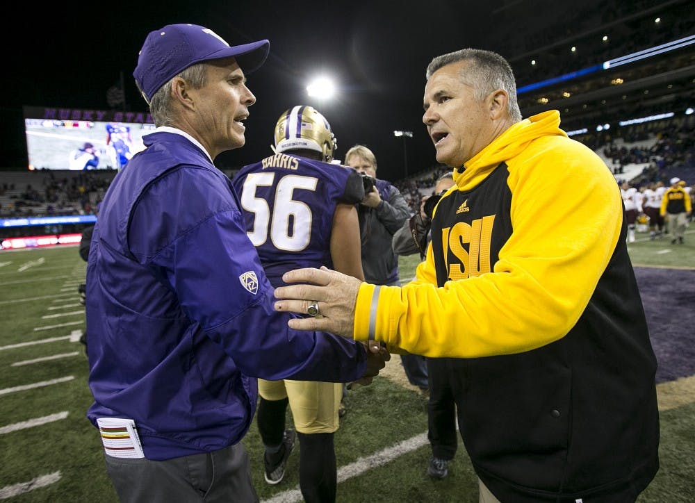 UW head coach Chris Petersen and ASU head coach Todd Graham shake hands after a football game against the UW Huskies on Saturday, Nov. 19, 2016, in Husky Stadium in Seattle, Washington. 