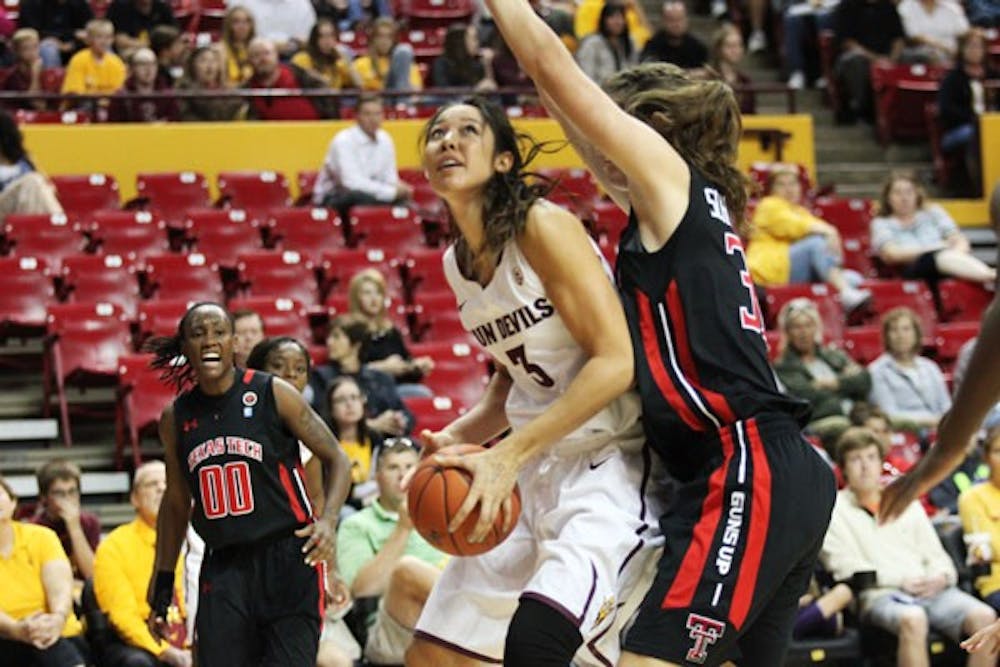 Junior forward/center Joy Burke looks for a shooting angle around a Texas Tech defender during the Sun Devils’ 61-49 loss to the Lady Raiders last Sunday. (Photo by Kyle Newman)
