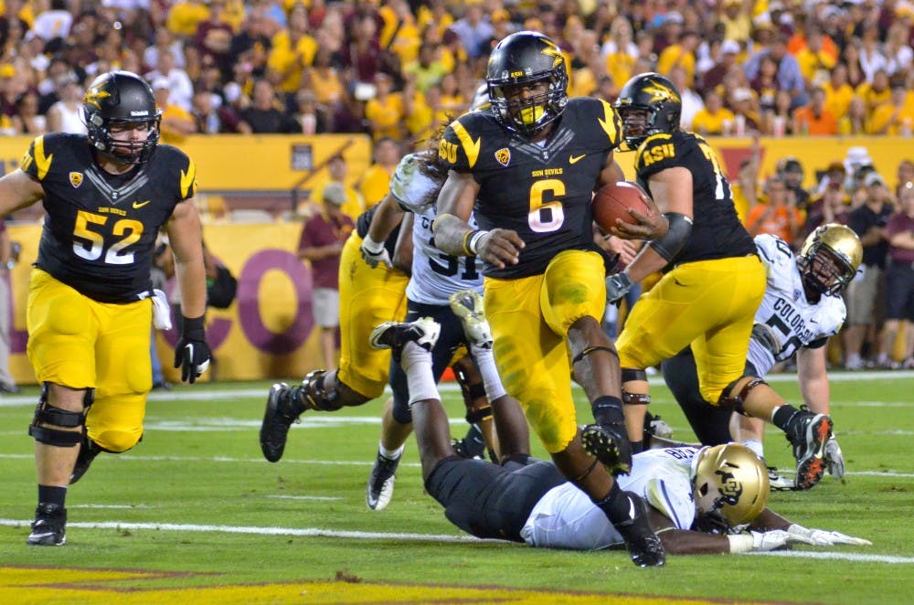 Senior running back Cameron Marshall rushes past defenders during last year’s Homecoming game against Colorado. Coach Todd Graham named Marshall as one of the team’s captains, along with redshirt senior linebacker Brandon Magee, redshirt senior offensive lineman Andrew Sampson and redshirt senior safety Keelan Johnson. (Photo by Aaron Lavinsky) 
