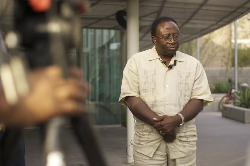 HOPING FOR THE BEST: Emmanuel Jigba, father of missing 24-year-old Willie Jigba, speaks to media reporters in front of the Tempe police station Thursday afternoon in hopes of receiving answers from the community.(Photo by Scott Stuk)