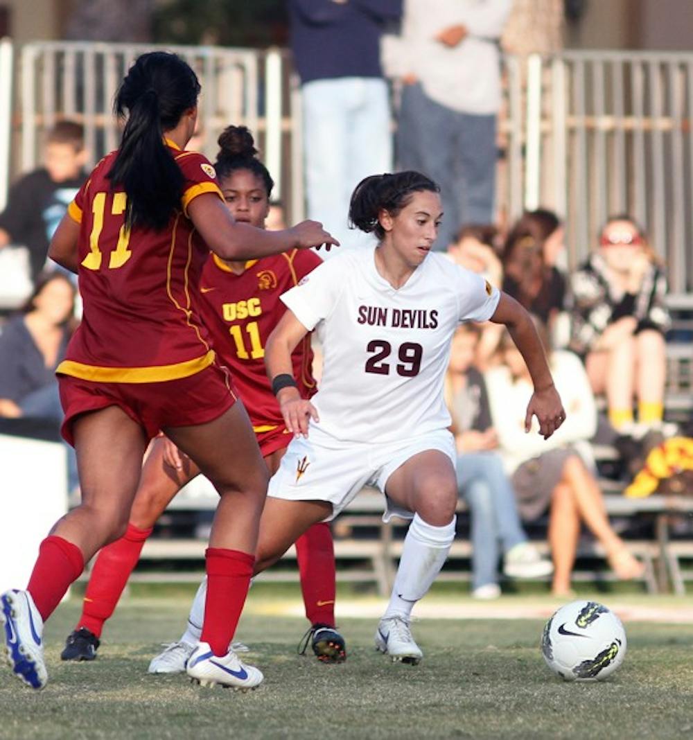 STUDENT-ATHLETE: ASU redshirt sophomore Nicki Stone creates space against two USC defenders during the Sun Devils’ overtime loss on Friday. Stone maintains a perfect GPA despite juggling a sport and a social life. (Photo courtesy of Steve Rodriguez)
