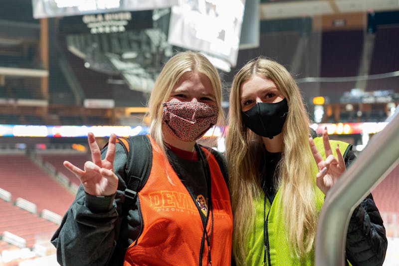 Rachel Williams (left) and Kiana Cripps (right) pose for a portrait in the Gila River Arena vaccine site in Glendale on Tuesday, May 18, 2021. Williams and Cripps are student workers at the vaccine sites.&nbsp;