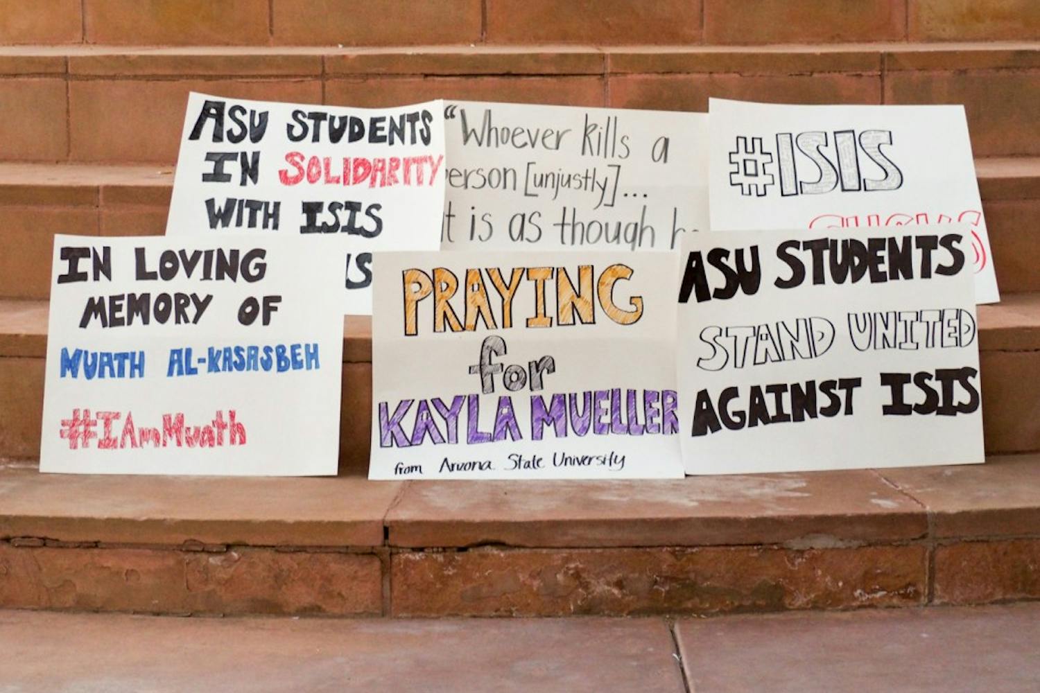 ASU students made signs to show sympathy for victims of the Islamic State of Iraq and Syria. The vigil was organized by student organizations to protest the actions of ISIS. (J. Bauer-Leffler/The State Press)