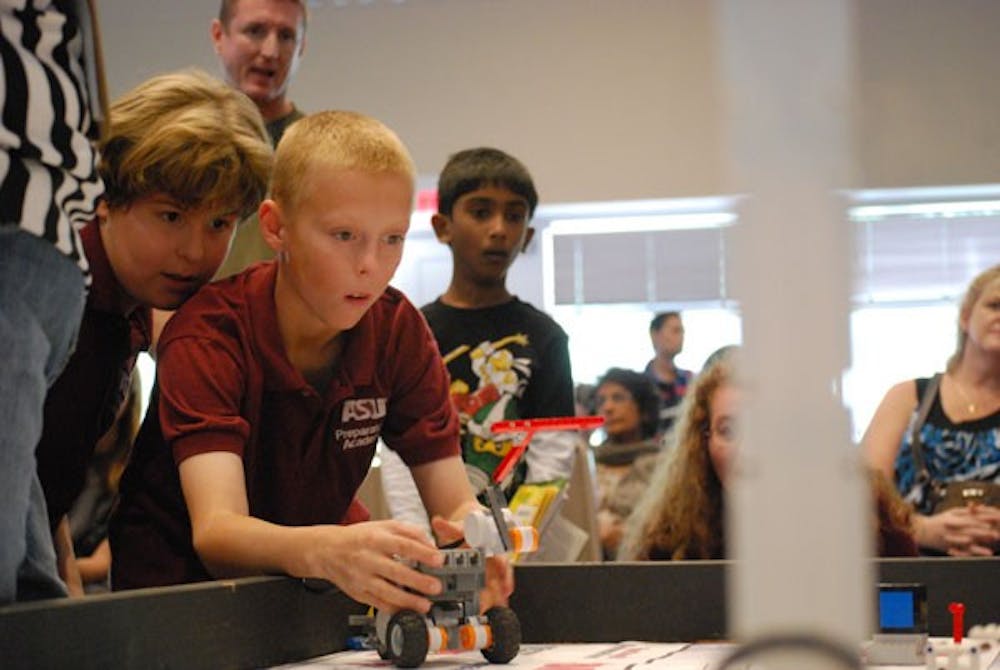 Ben Voller-Brown, 11, of the ASU Preparatory Academy team, tests the team's LEGO robot during the FIRST LEGO League robot battle at the Polytechnic campus on Nov.17. (Photo by Murphy Bannerman)