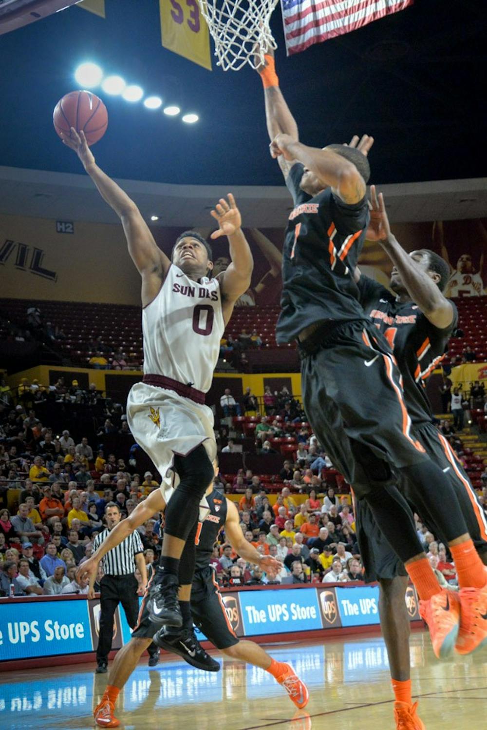 Freshman guard Tra Holder makes a layup against heavy defense on Wednesday, Jan. 28, 2015, at Wells Fargo Arena. The Sun Devils went on to win the game against OSU. (J. Bauer-Leffler/The State Press)