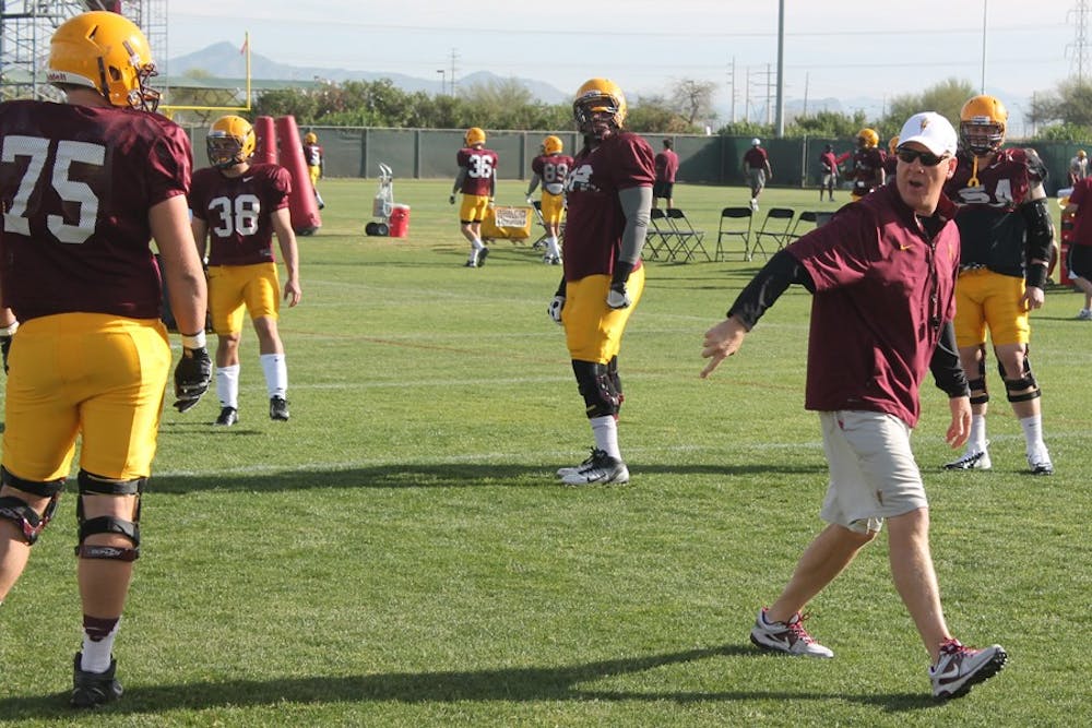 Offensive linemen coach Chris Thomsen shifts his eyes to each of his players looking for something to correct. Thomsen has already made an impact on the linemen in his first five practices with the team. (Photo by Edmund Hubbard)