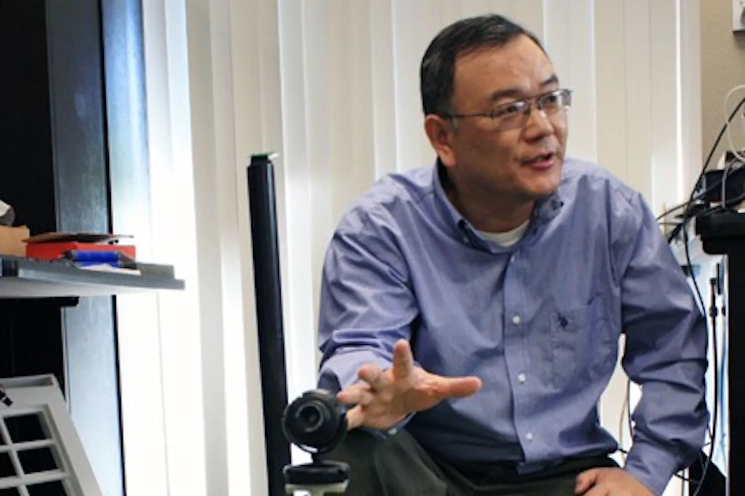 Lecturer Yinong Chen explains the construction and idea of a previously constructed robot similar to the one three ASU students will build in a competition in China this summer. (Photo by Jessie Wardarski)