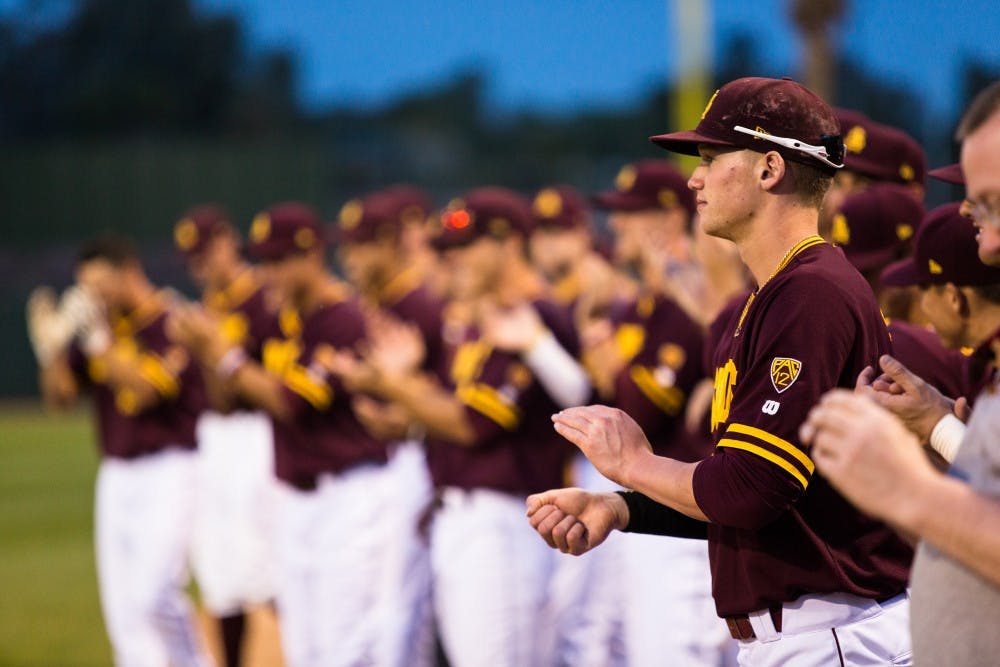 ASU junior outfielder Johnny Sewald claps during introductions at the ASU vs. Oklahoma baseball game at Phoenix Municipal Stadium on Feb. 18, 2015. Sewald had three hits and an RBI to help the Sun Devils would defeat the Sooners 7-4. (Daniel Kwon/The State Press)