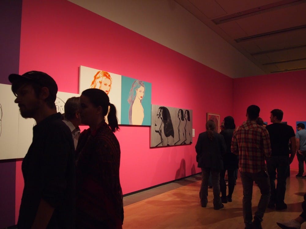 Visitors crowd around artwork from the Andy Warhol exhibit at the Phoenix Art Museum on March 6, 2015. (Kaitlyn Ahrbeck/The State Press)