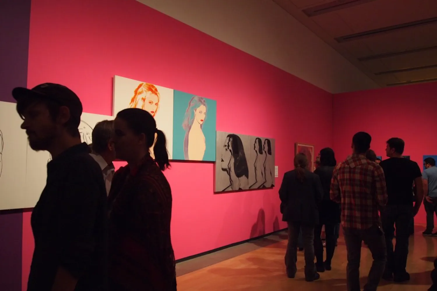 Visitors crowd around artwork from the Andy Warhol exhibit at the Phoenix Art Museum on March 6, 2015. (Kaitlyn Ahrbeck/The State Press)