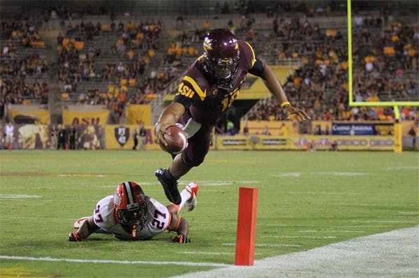 Redshirt freshman quarterback Michael Eubank dives over the pylon for a touchdown during the Sun Devils’ 45-14 win over Illinois on Sept. 8. (Photo by Kyle Newman)
