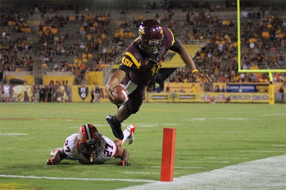 Redshirt freshman quarterback Michael Eubank dives over the pylon for a touchdown during the Sun Devils’ 45-14 win over Illinois on Sept. 8. (Photo by Kyle Newman)
