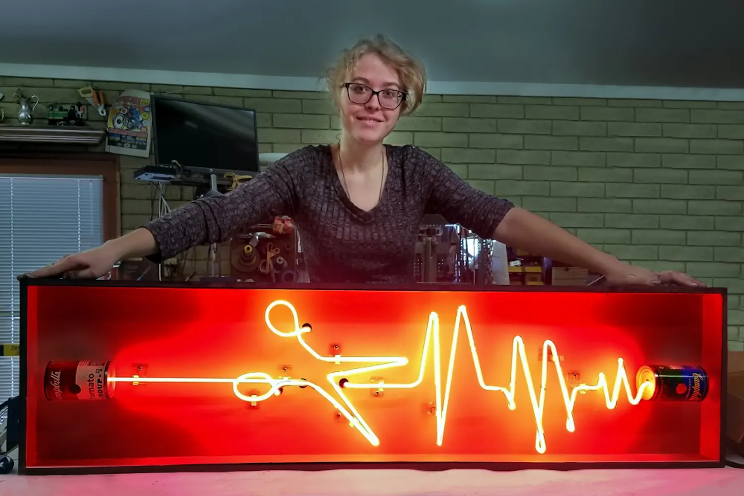 ASU psychology student Makita White poses with her piece titled "Can You Hear Me" in her workspace in Tempe, Arizona.
