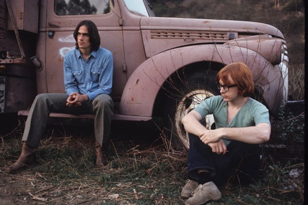Peter Asher sits with James Taylor in-between taking photos for the album cover for "Sweet Baby James" at The Farm in December 1969.  (Photo courtesy of Henry Diltz)