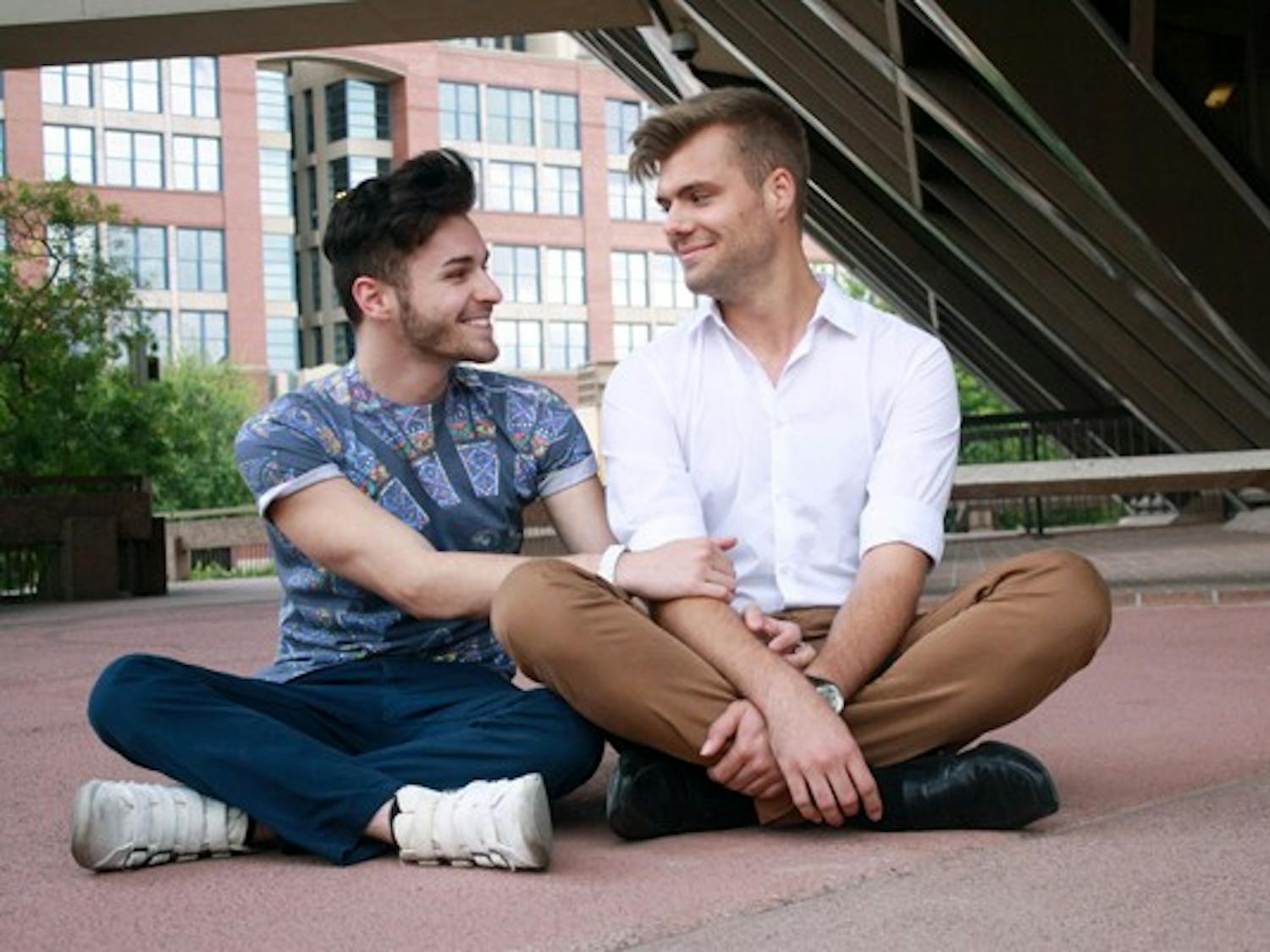 Juniors Alexander Mach (right) and Michael Howard sit outside of the Tempe City Hall Building. The City of Tempe has expressed interest in legalizing civil unions, and although Mach and Howard’s relationship is fairly new, they say they are excited by the city’s progressive attitude toward gay rights. (Photo by Hector Salas Almeida)