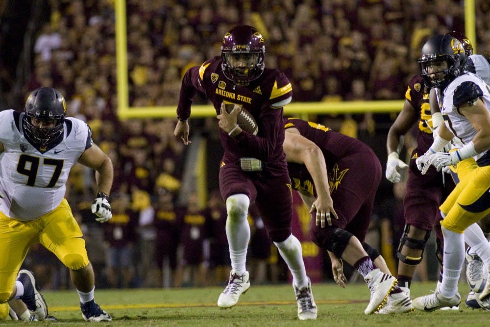 ASU redshirt sophomore quarterback Manny Wilkins takes off through the middle of the field on a quarterback run in the first half of the game versus the California Golden Bears in Sun Devil Stadium in Tempe, Arizona, on Saturday, Sept. 24, 2016. 