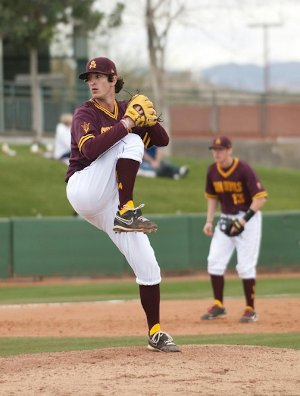 Freshman pitcher Brett Lilek raises his knee during his delivery in the ASU alumni game on Feb. Lilek has proved himself in these early games and might get a start this weekend in the Coca-Cola Classic. (Photo by Molly J. Smith)
