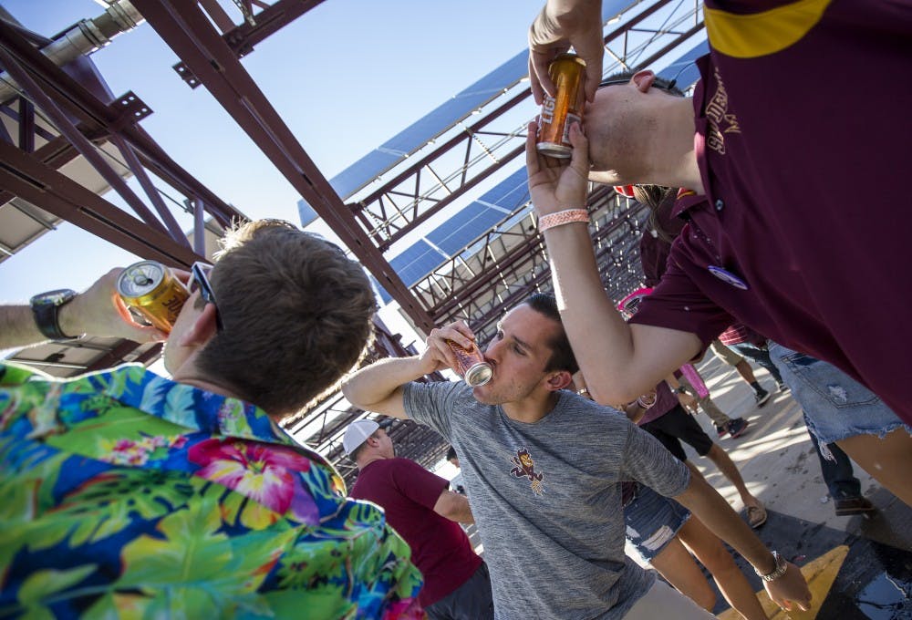 Fans tailgate in a parking garage across from Sun Devil Stadium before an ASU football game against the California Golden Bears on Saturday, Sept. 24, 2016. 