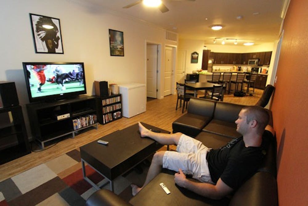 Accounting senior Craig Koenig watches TV in his new Villas at Vista del Sol apartment on Thursday.  The Villas opened to student residents this fall across from the Student Recreation Complex.  (Photo by Sam Rosenbaum)