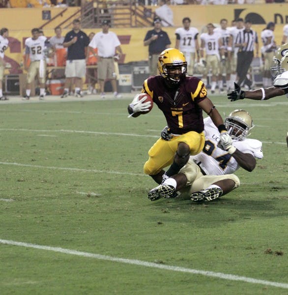 ALL-AROUND: ASU sophomore wide receiver Kyle Middlebrooks tries to break a tackle during the Sun Devils victory over UC Davis on Sept. 1. The versatility and athleticism that Middlebrooks and junior Jamal Miles provide has been a major part of the Sun Devils’ success so far this season. (Photo by Beth Easterbrook)