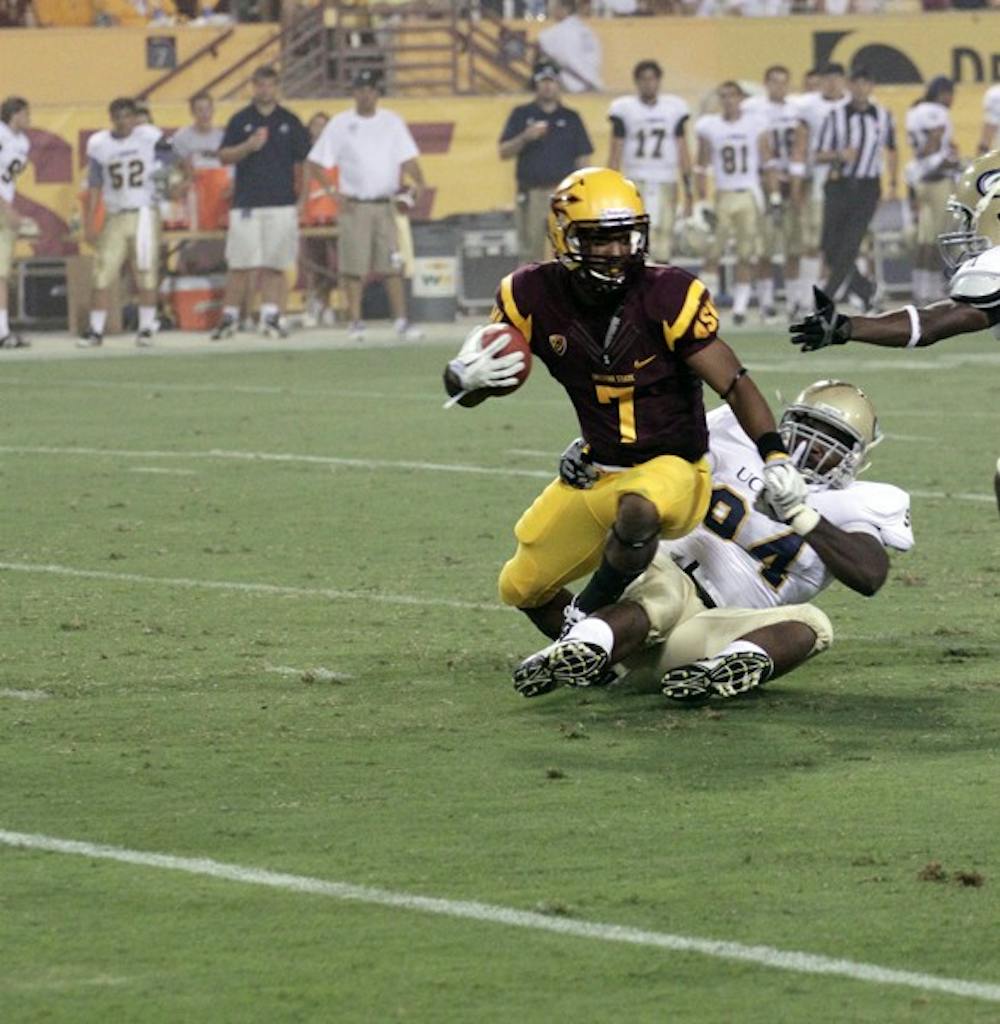 ALL-AROUND: ASU sophomore wide receiver Kyle Middlebrooks tries to break a tackle during the Sun Devils victory over UC Davis on Sept. 1. The versatility and athleticism that Middlebrooks and junior Jamal Miles provide has been a major part of the Sun Devils’ success so far this season. (Photo by Beth Easterbrook)