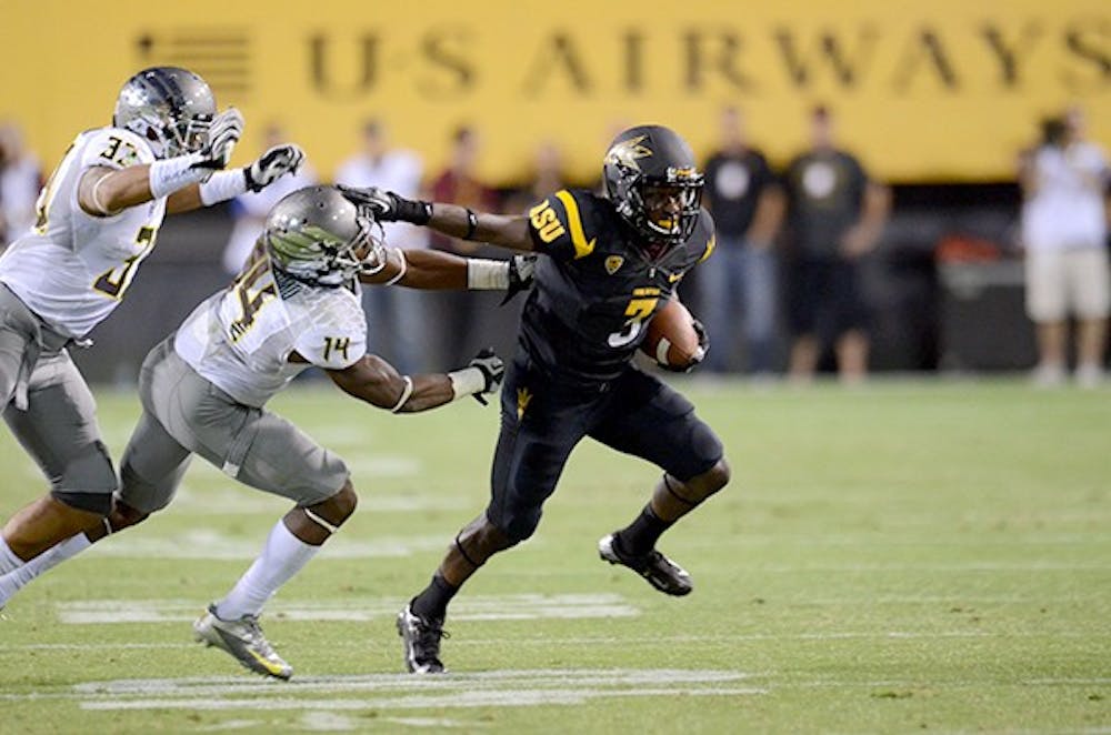 Sophomore wide receiver Richard Smith avoids two Oregon players during a game in 2012. no. 3 oregon goes head to head with No. 12 UCLA this weekend while the sun devils have a bye week. (Photo by STate Press Staff) 