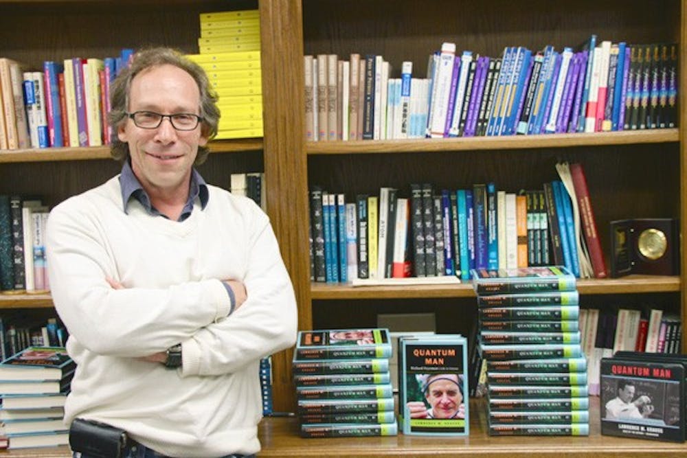 QUANTUM MAN: Professor Lawrence Krauss stands next to a collection of his newly released book and audio CDs. (Photo by Rosie Gochnour)