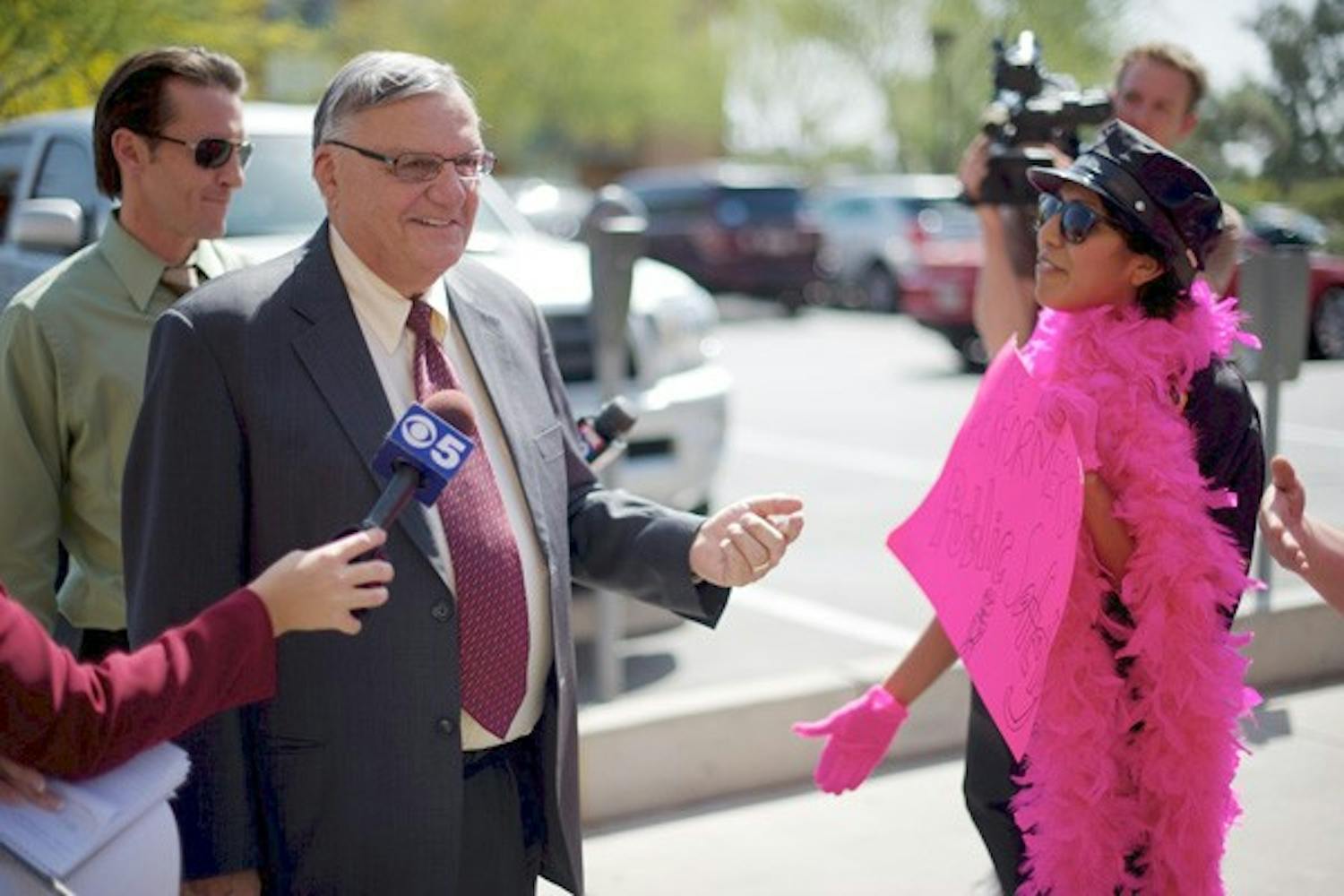 PROTESTING IN PINK: Students identified as Performers for Public Safety confronted Maricopa County Sheriff Joe Arpaio with police outfits covered in pink boas while he visited ASU on Thursday to discuss immigration issues. (Photo by Michael Arellano) 