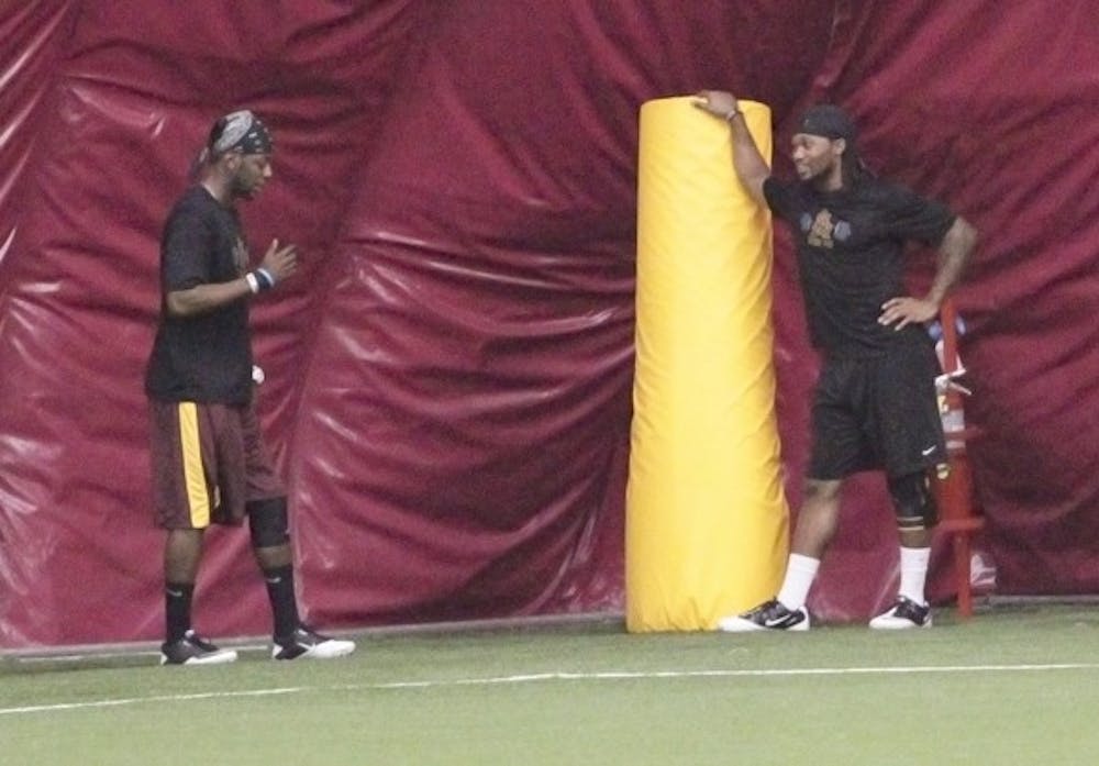 STILL INVOLVED: ASU redshirt freshman cornerback Devan Spann (left) chats with redshirt senior Omar Bolden off the field during practice. Both players had surgery before the start of the season and will likely miss this entire year. (Photo by Beth Easterbrook)