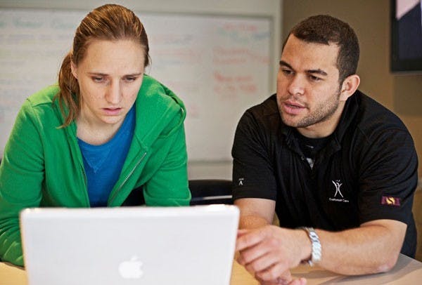 SYSTEM UPGRADES: Postgraduate student Anna Berlin receives IT assistance from Jorge Morales, who works in the student-run Technology Studio, located inside the Computing Commons building. ASU is set to be upgrading their version of Blackboard as well as upgrading to Windows 7, amongst other upgrades. (Photo by Michael Arellano)