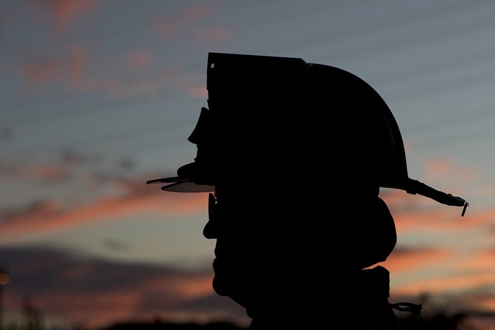Healing Field Sentinel Bill Marhsall takes watch over Tempe Beach Park Friday, Sept. 11, 2015 in Tempe. Marshall has attended this memorial since it started in 2004. 