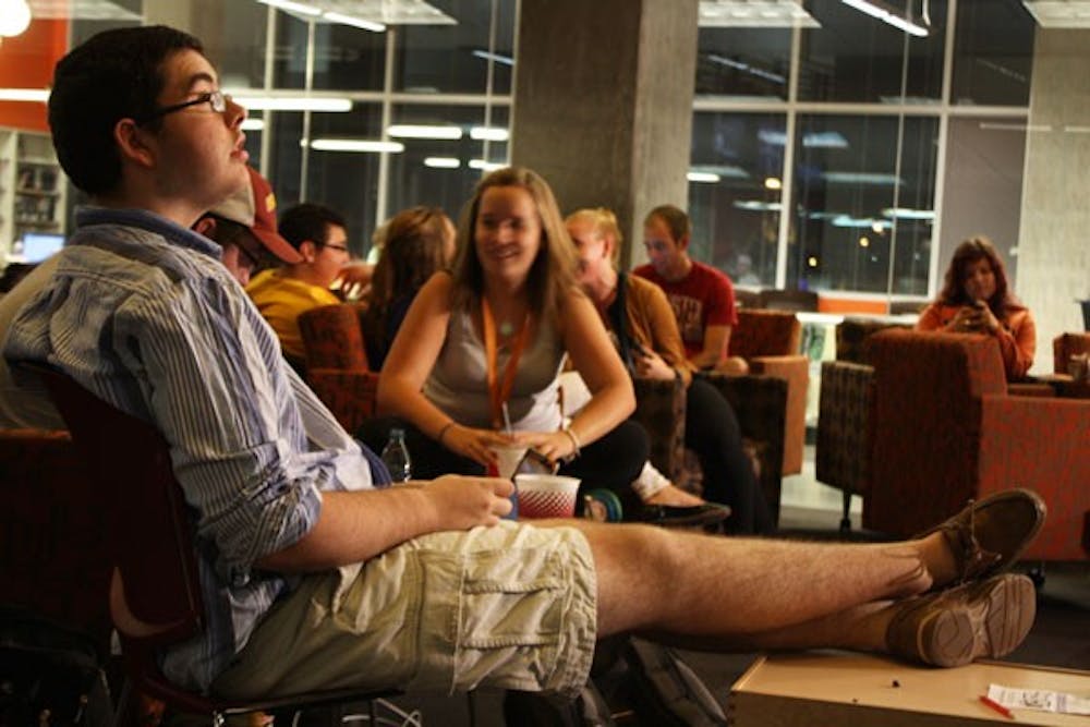 Journalism freshman Nick Krueger keeps his eyes on the large TV screen in the First Amendment Forum at the Walter Cronkite School of Journalism and Mass Communication, as the polling results streamed on CNN's live coverage of the presidential election late Tuesday evening. (Photo by Jessie Wardarski)