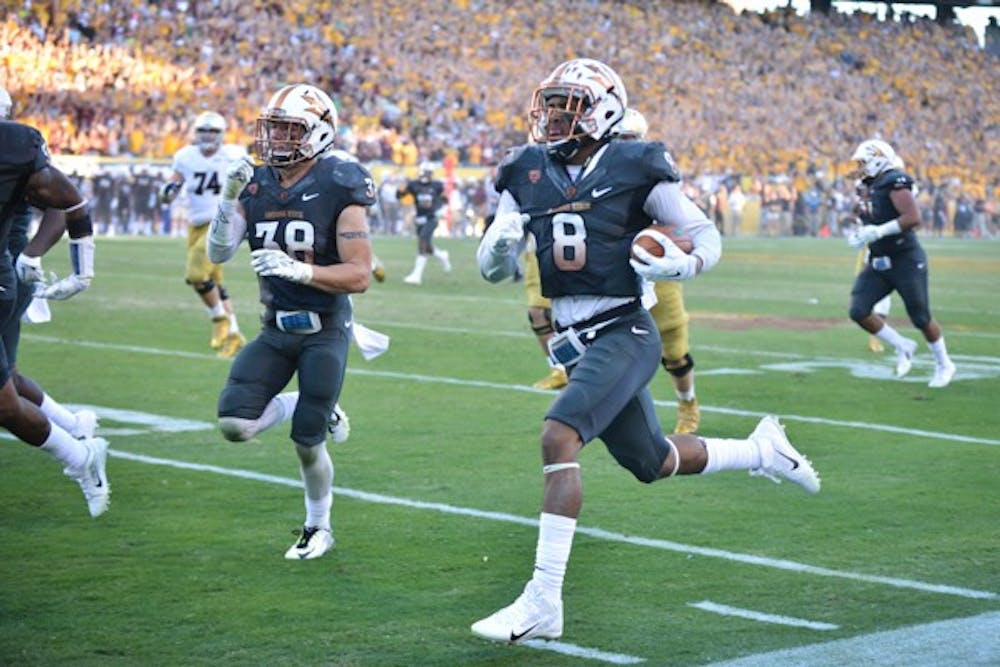 Junior running back D.J. Foster carries the ball for a touchdown against Notre Dame on Nov. 8, 2014. ASU defeated Notre Dame 55-31 at Sun Devil Stadium. (Photo by Andrew Ybanez)