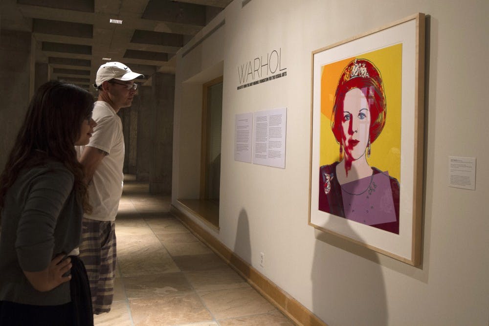 Robert Jones and his daughter Jessica Jones look at Andy Warhol’s Queen Beatrix screenprint at the ASU Art Museum on June 3, 2014. The museum received six Warhol prints as a short-term donation from the Andy Warhol Foundation for the Visual Arts. (Photo by Sean Logan)