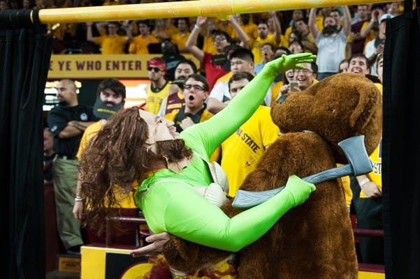 Members of the 942 Crew attempt to disrupt a UCLA free throw attempt behind the "Curtain of Distraction" on Wednesday, Feb. 18, 2015, at Wells Fargo Arena. (Ben Moffat/The State Press)