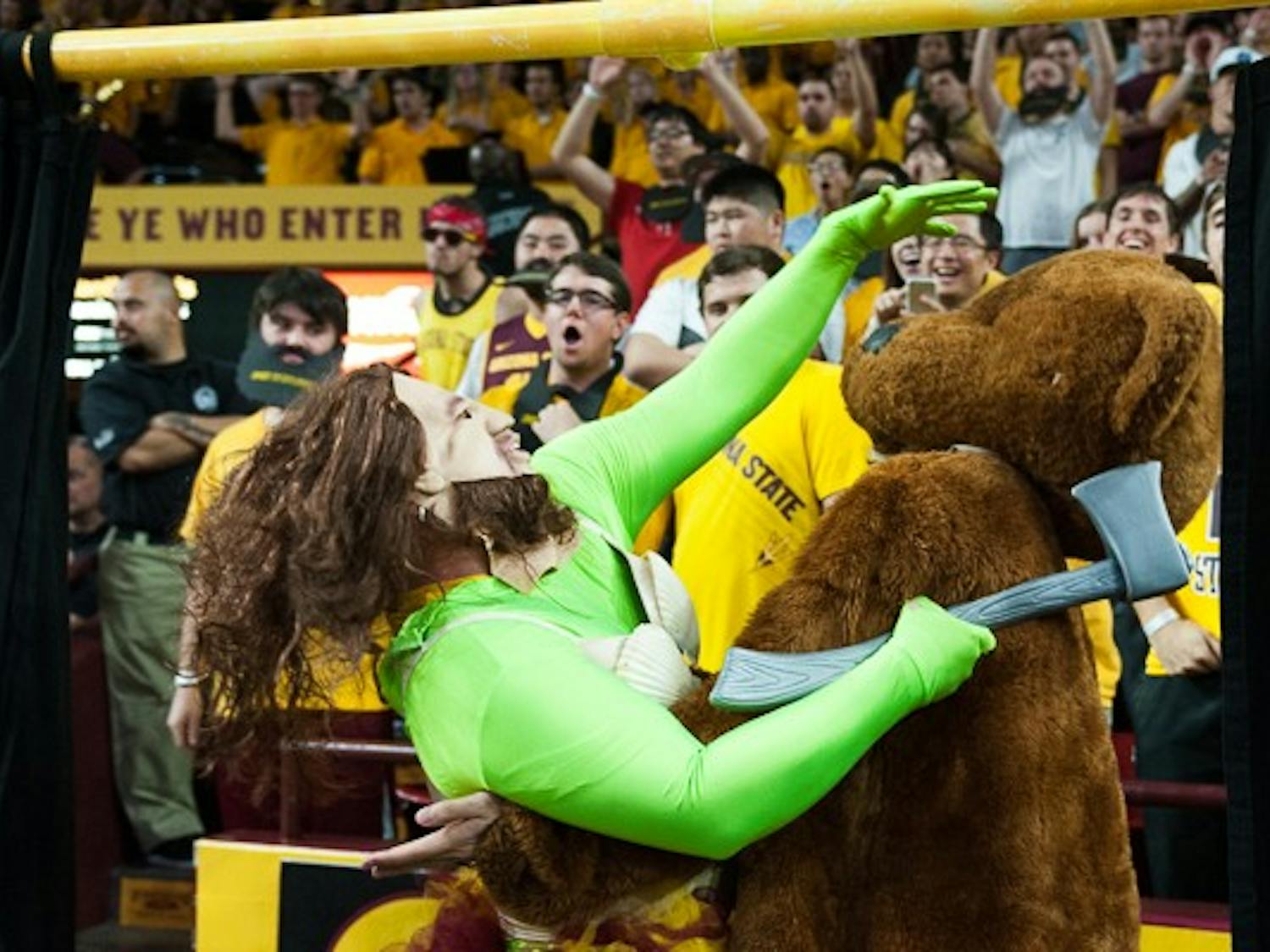 Members of the 942 Crew attempt to disrupt a UCLA free throw attempt behind the "Curtain of Distraction" on Wednesday, Feb. 18, 2015, at Wells Fargo Arena. (Ben Moffat/The State Press)