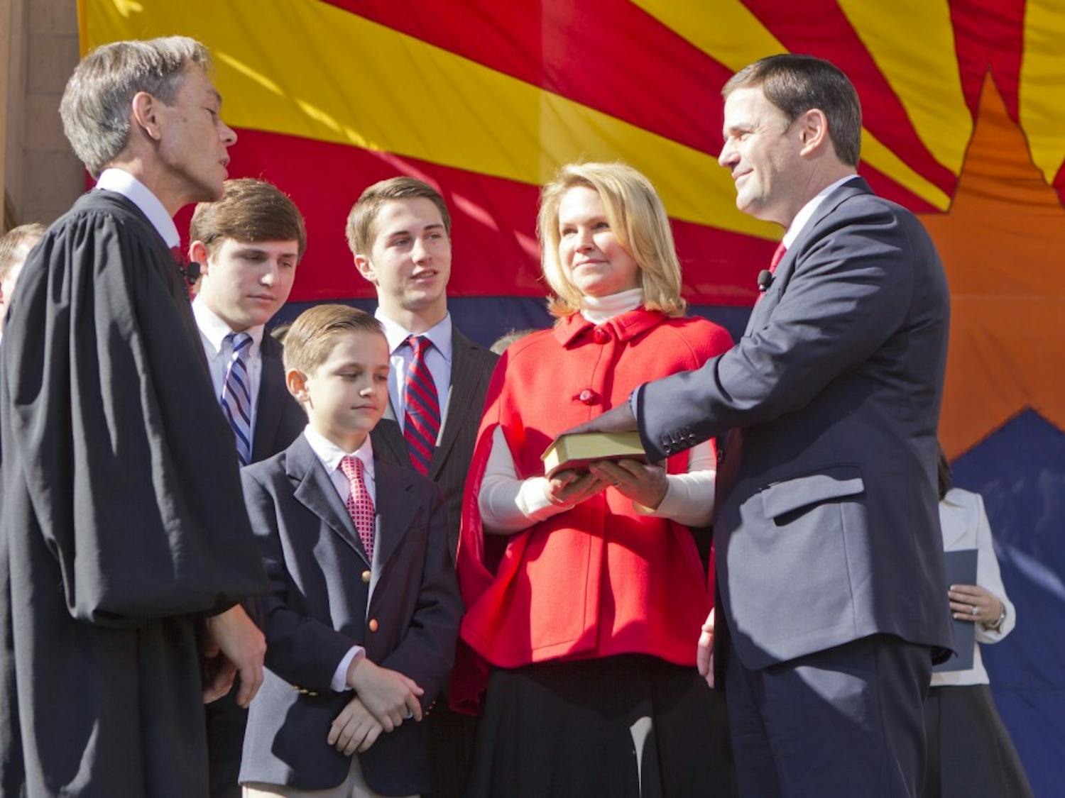 Doug Ducey taking his oath to office as Arizona's governor with his family beside him.  The inauguration took place at the State Capitol courtyard on January 5, 2015.  (Photo by Emily Johnson)