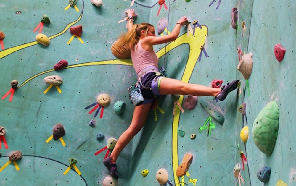 Caitlin MacMurtrie scales a wall at the Phoenix Rock Gym. Photo by Jessica Heigh.