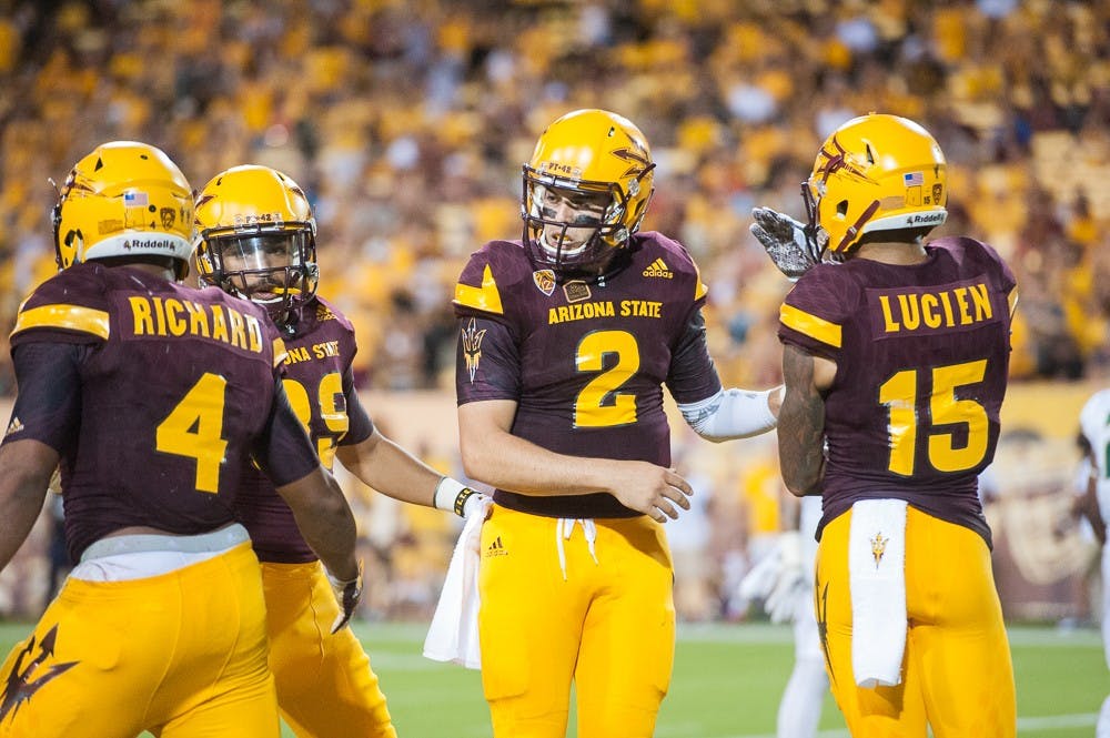 Redshirt senior quarterback Mike Bercovici (2) celebrates after sophomore running back Demario Richard (4) scored a touchdown against Cal Poly on Saturday, Sept. 12, 2015, at Sun Devil Stadium in Tempe.